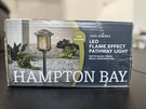 Hampton Bay Ambrose Low Volt 2.4 Lumen Led Path Light W/ Flicker Flame Effect. Fixed Price $30.00.